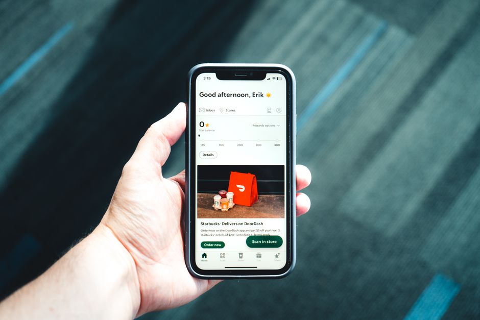 Hand holding a smartphone displaying a 'cancel subscription' button, symbolizing budget management.