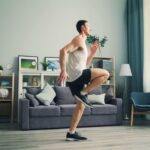 A person performing a yoga pose in a bright living room, symbolizing indoor winter fitness.