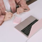 A small business owner using a laptop, with a magnifying glass icon hovering over text on the screen, symbolizing fact-checking AI output.