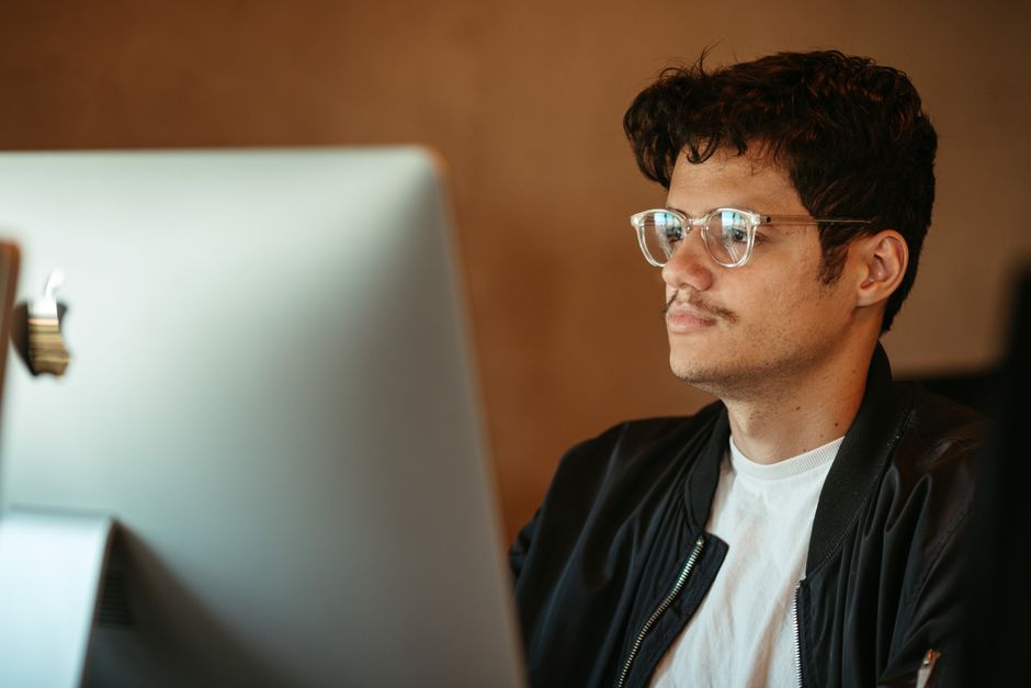 A person's hands typing on a laptop, with a glowing padlock icon overlayed on the screen, representing data privacy and security