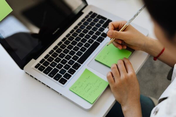 A remote worker calmly managing digital tasks on a laptop in a tidy home office, symbolizing effective automation.
