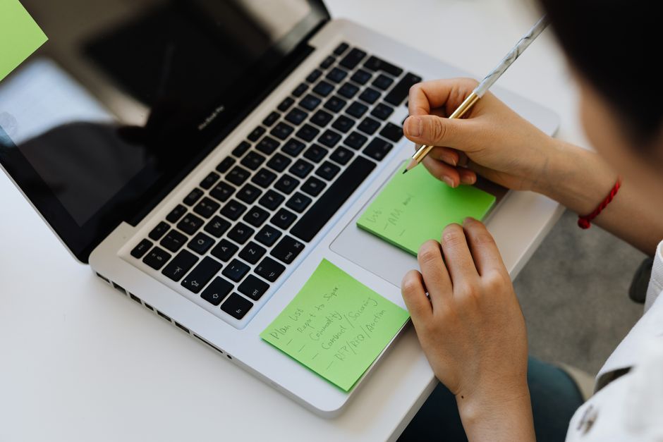 A remote worker calmly managing digital tasks on a laptop in a tidy home office, symbolizing effective automation.