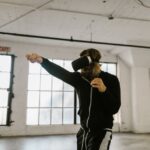 A person wearing a VR headset vigorously punching virtual targets in a fitness game, demonstrating an active workout.