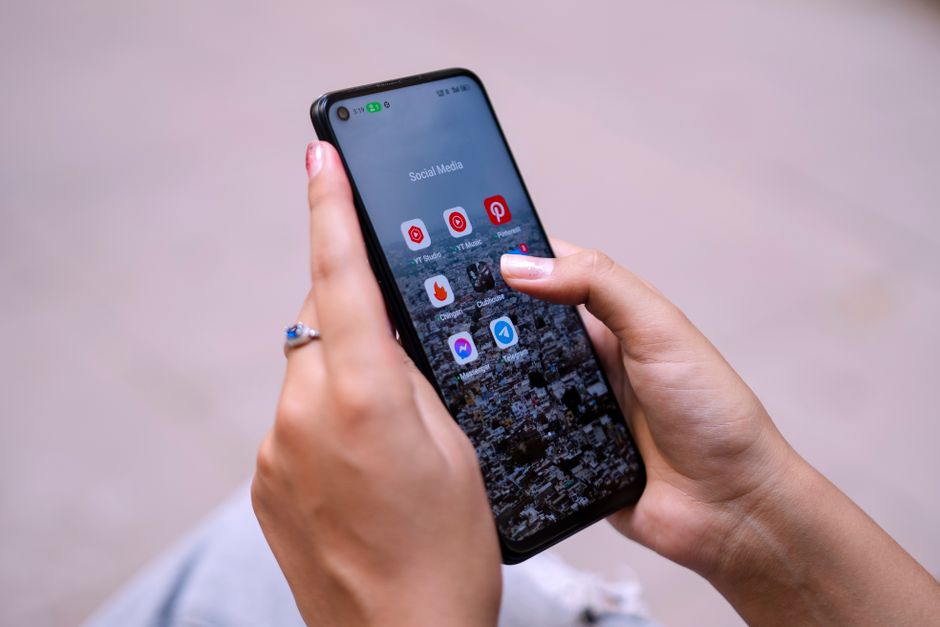 Illustration of a person engrossed in their smartphone, with numerous notification icons floating around them, symbolizing digital distraction.