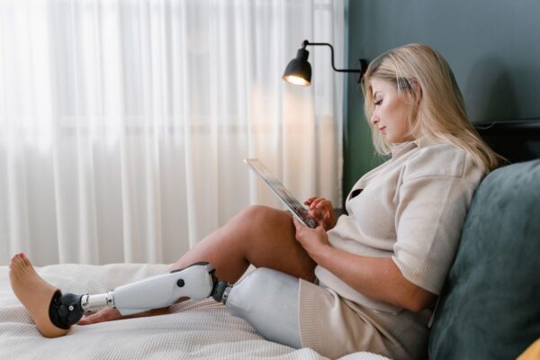 A person using a tablet with a holographic AI assistant overlay, demonstrating personalized language practice with immediate feedback.