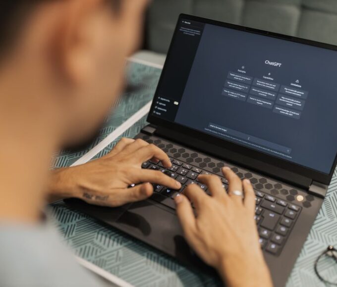 Person looking frustrated while typing at a laptop, with a generic AI chatbot interface on screen.