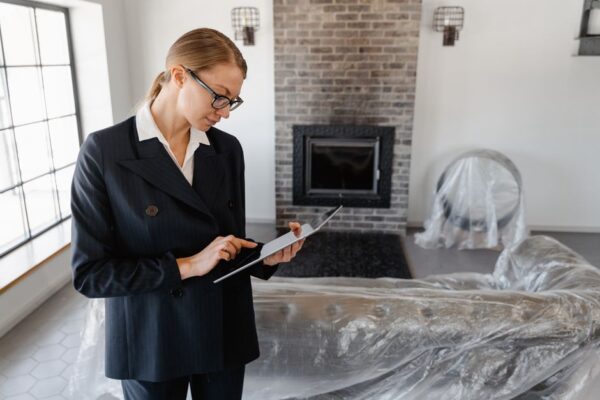 A person using a tablet, an AI interface showing various housing options and neighborhood data superimposed on the screen.