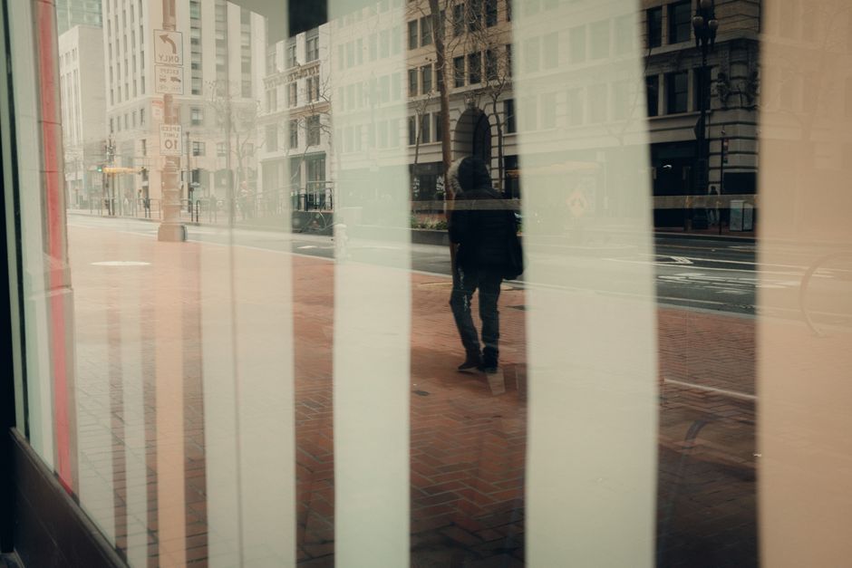A person in comfortable walking shoes navigating a vibrant, historic pedestrian street in a European city, surrounded by old buildings.