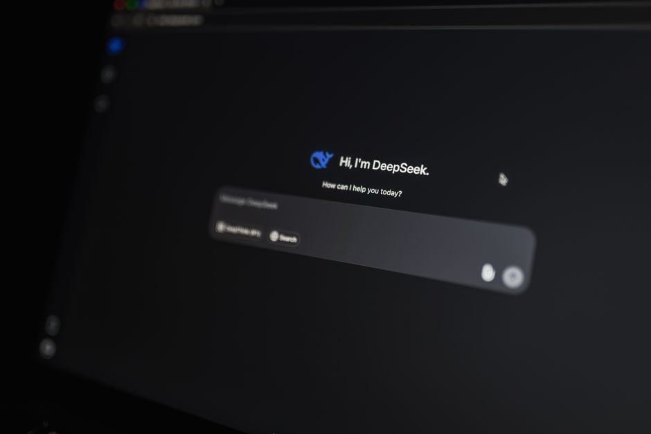 A person thoughtfully typing on a laptop, with an abstract AI interface layered over the screen, suggesting prompt creation.
