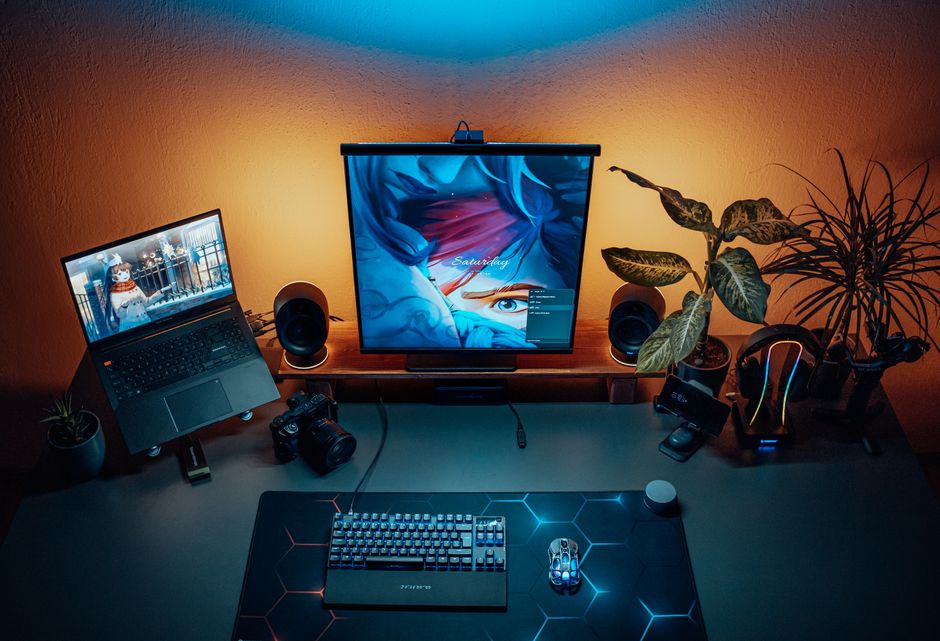 A sleek, understated gaming laptop open on a professional desk setup, showcasing its dual use for work and gaming without flashy aesthetics.