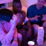 Three roommates chatting comfortably in a tidy, modern living room, representing positive communication in a shared apartment.