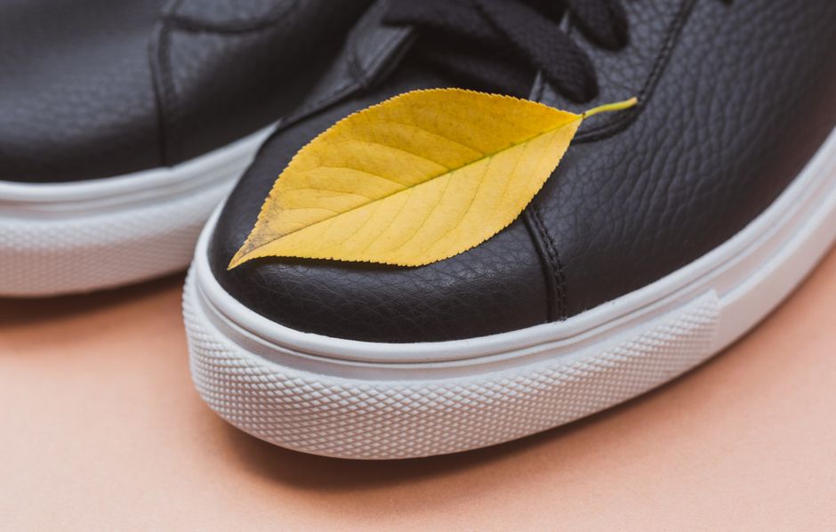 Close-up of a pair of high-quality, minimalist white leather sneakers with a low profile, ideal for versatile styling.