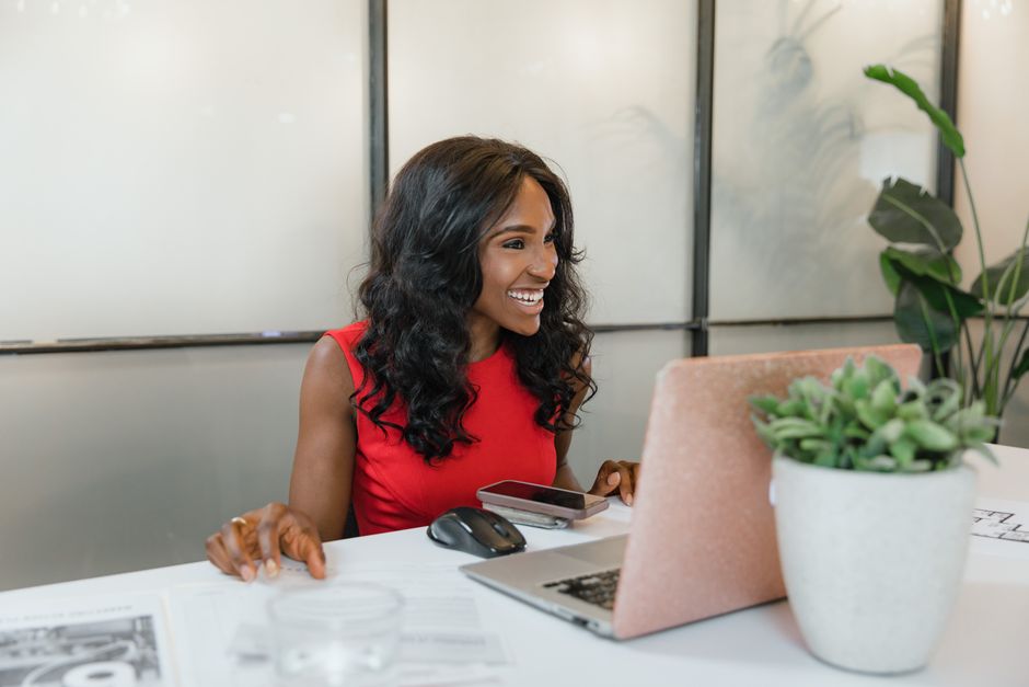 A small business owner uses a laptop with a prominent digital lock icon superimposed, symbolizing secure data and privacy, in an office setting.