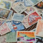 A passport open to pages with multiple colorful immigration stamps from various South American countries, highlighting international travel.