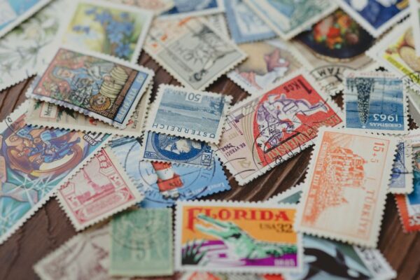 A passport open to pages with multiple colorful immigration stamps from various South American countries, highlighting international travel.