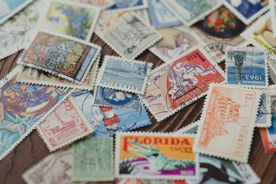 A passport open to pages with multiple colorful immigration stamps from various South American countries, highlighting international travel.