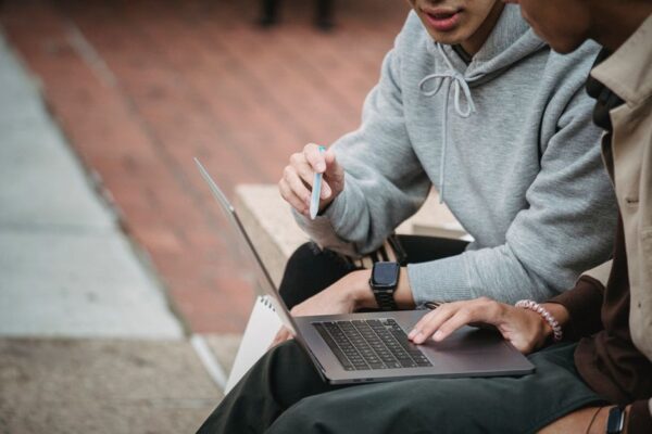 A student looking at a laptop screen with various privacy settings displayed, representing control over personal data and AI interactions.