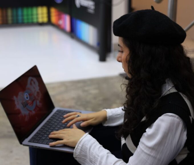 A student in a modern library setting, using a laptop, with abstract AI interface elements overlaid, symbolizing the integration of AI tools for study.