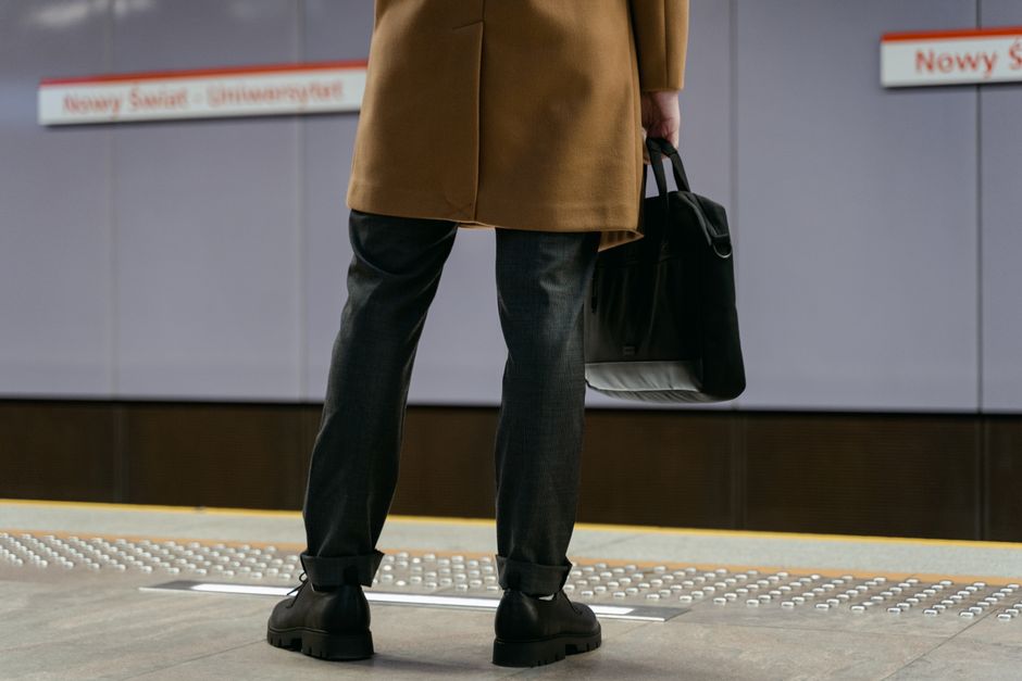A commuter's feet on subway stairs, showcasing comfortable and durable shoes designed for urban travel.