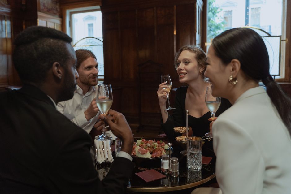 A detailed comparison table showing different office-to-dinner outfit strategies specific to cities like Toronto, Milan, and New York, with examples of daytime and evening items.