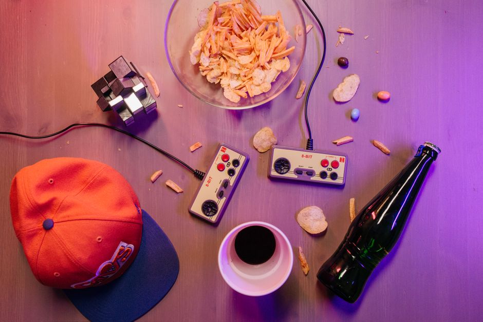 A well-organized table laden with a selection of board games, fun snacks, and refreshing drinks, ready for a family game night.