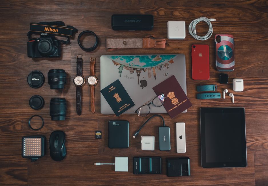 A sleek tablet displaying a movie next to a compact, fully charged power bank, ready for use on a travel tray table.