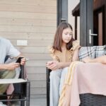 A parent and teenager having an open conversation about AI tools, with a tablet showing various apps.