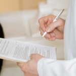 Traveler speaking with a doctor at a travel clinic, discussing necessary vaccinations and health precautions before a trip to the Americas.