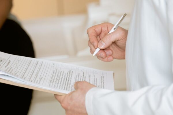 Traveler speaking with a doctor at a travel clinic, discussing necessary vaccinations and health precautions before a trip to the Americas.