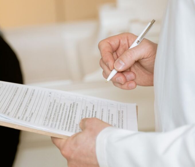 Traveler speaking with a doctor at a travel clinic, discussing necessary vaccinations and health precautions before a trip to the Americas.