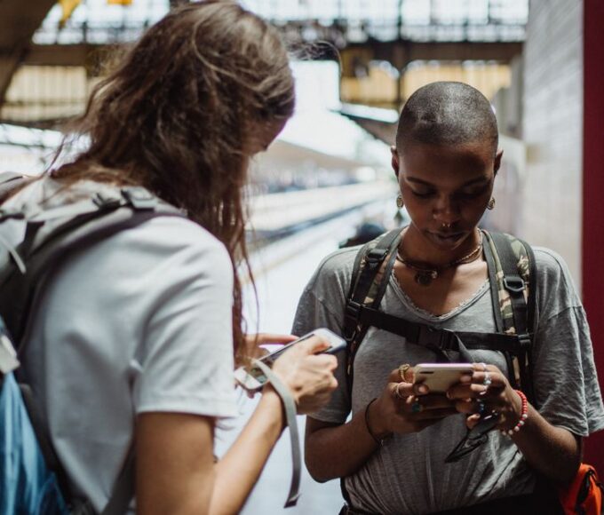 A traveler in a bustling European square looking at their phone, representing seamless connectivity with an eSIM.