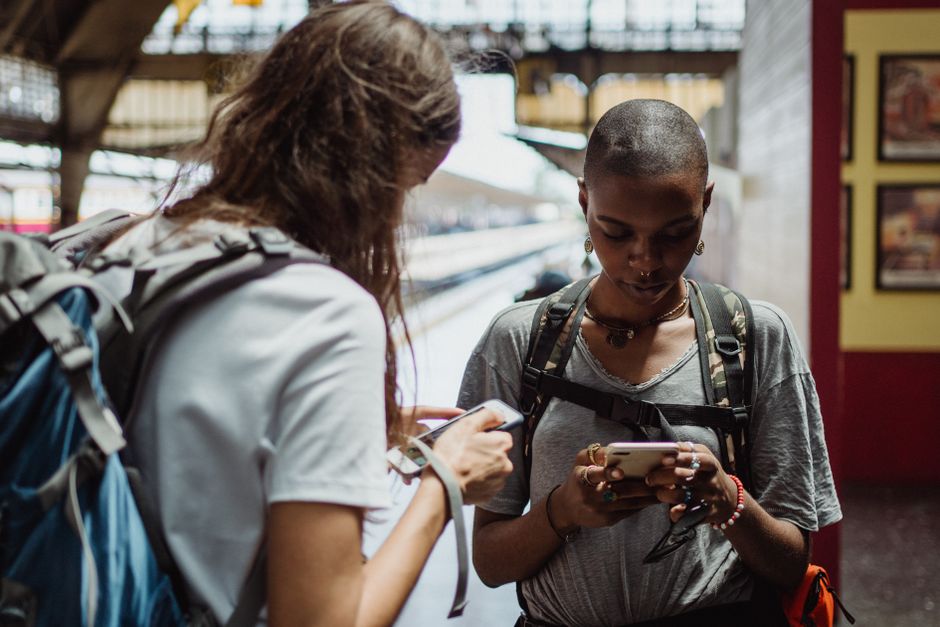 A traveler in a bustling European square looking at their phone, representing seamless connectivity with an eSIM.