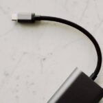 A close-up shot showing several different USB-C cables, some thicker than others, hinting at varied capabilities.