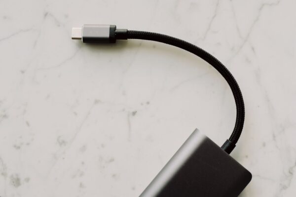 A close-up shot showing several different USB-C cables, some thicker than others, hinting at varied capabilities.