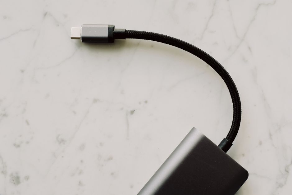 A close-up shot showing several different USB-C cables, some thicker than others, hinting at varied capabilities.