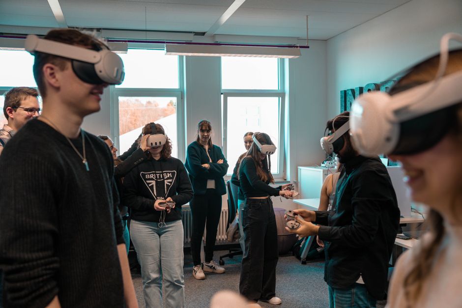 A bustling virtual city scene from a video game, showing diverse NPCs interacting with each other and the environment, suggesting advanced AI.