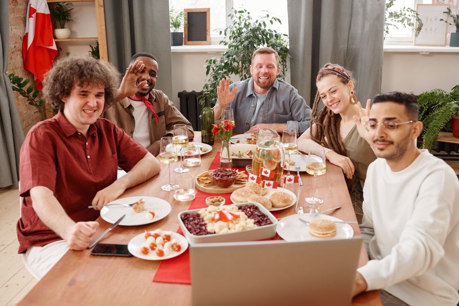 A diverse group of remote team members smiling and interacting warmly during a lively video conference call, illustrating positive virtual connection.